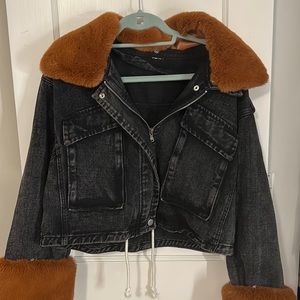 Black denim jacket with removable fur sleeves.